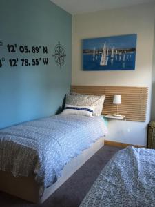 a bedroom with a bed and a clock on the wall at Snowdon View in Llanberis