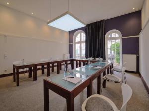 a conference room with tables and chairs and a large window at Classik Hotel Antonius Köln City in Cologne