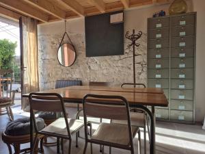 a dining room with a wooden table and chairs at Naëlo Chartreuse in Biviers +11 photos