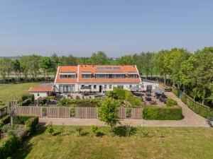 an aerial view of a large house with a garden at B&B Plompetorenzicht in Burgh Haamstede