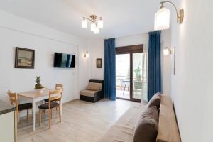 a living room with a table and a dining room at Azur Apartments by Paralia Living in Nikiti