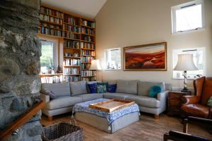 a living room with a couch and a table at Ty Uchaf in Colwyn Bay +28 photos