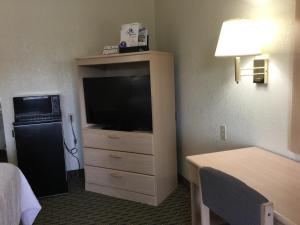 a hotel room with a flat screen tv in a dresser at Americas Best Value Inn Cabot in Cabot