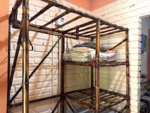 a iron bunk bed in a room with a brick wall at Pousada da Chacara in Nova Petrópolis
