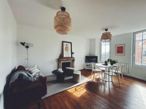 a living room with a couch and a table at Suite Jaurès in Rethel