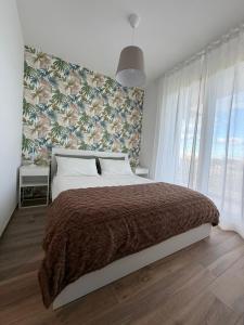 a bedroom with a large bed with a floral wall at MH Lippolis in Bari