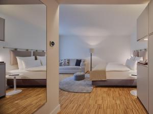 a bedroom with a bed and a couch at Classik Hotel Hackescher Markt - Self Check In in Berlin