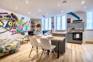 a kitchen and living room with a table and chairs at Les apparts du TRECH in Tulle