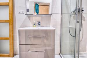 a bathroom with a sink and a shower at Les apparts du TRECH in Tulle +35 photos