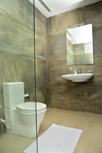 a bathroom with a toilet and a sink at Ayurvedic Beach Resort in Negombo +26 photos