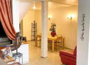 a living room with a table and a dining room at La Rose du Château in Lourdes