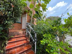 a brick house with stairs leading to a door at Casa Carito in Cali