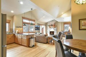 a kitchen and living room with a table and chairs at Mt. Victoria Lodge Penthouse Condo: Downtown, Hot Tub in Frisco