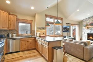 a kitchen and living room with a couch at Mt. Victoria Lodge Penthouse Condo: Downtown, Hot Tub in Frisco +36 photos