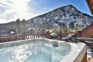 a hot tub on a deck with a mountain at Mt. Victoria Lodge Penthouse Condo: Downtown, Hot Tub in Frisco