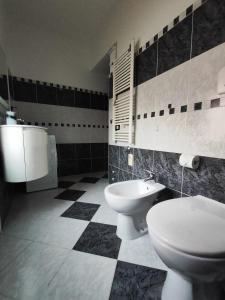 a bathroom with a toilet and a bidet at Margherita in Seriate +2 photos