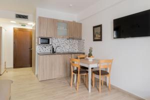 a kitchen and dining room with a table and chairs at Azur Apartments by Paralia Living in Nikiti