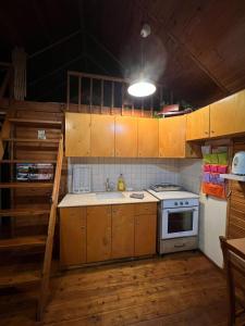 a kitchen with wooden cabinets and a stove top oven at בקתת העץ של מירה ואמיר in Beit Hillel +13 photos