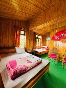a bedroom with a bed in a wooden room at Red Panda Ecohut in Lava