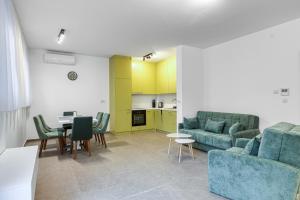 a living room with a couch and a table at Green Oasis Bečići in Boreti