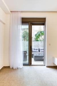 a living room with a sliding glass door at Green Oasis Bečići in Boreti +1 photo
