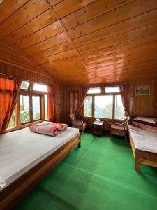 a bedroom with a large bed and a wooden ceiling at Red Panda Ecohut in Lava +8 photos
