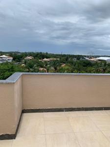 a wall with a balcony with a view of a city at Paraiso dos coqueiros - Guarajuba - Bahia -Linha verde in Camaçari