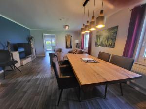a dining room with a wooden table and chairs at 03 Blumenwiese - Hof Wiesengrund in Parchtitz