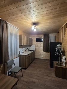 a kitchen with a sink and a table with a chair at Chalet Gudauri in Gudauri +11 photos