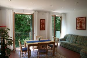 a living room with a table and chairs and a couch at Hupfmühle Pension in St. Wolfgang
