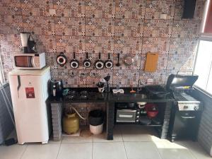 a kitchen with a sink and a stove and a refrigerator at Amsterdam Lofts Deluxe in Poços de Caldas +7 photos