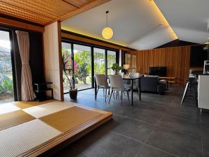 a living room with a table and chairs at Ryukyu Garden in Nanjo