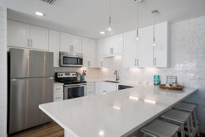 a kitchen with white cabinets and a white counter top at Dune Villas 2A - Gulf Front Vacation Condominium with Shared Pool in Santa Rosa Beach