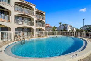 a swimming pool in front of a apartment building at Dune Villas 2A - Gulf Front Vacation Condominium with Shared Pool in Santa Rosa Beach