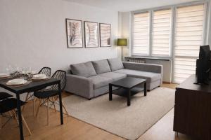 a living room with a couch and a table at Apartament Słoneczny in Zamość