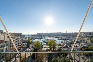 a view of a harbor from a balcony of a building at Zeas Yacht View in Piraeus