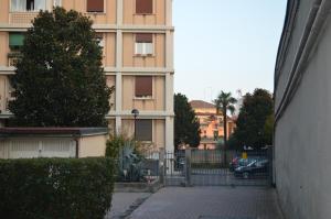 a building with a gate in front of a street at Cologno Centro Apartment in Cologno Monzese
