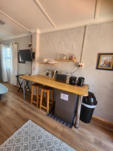 a kitchen with a wooden table and a counter top at Cottages on Ilchester in Grahamstown +30 photos