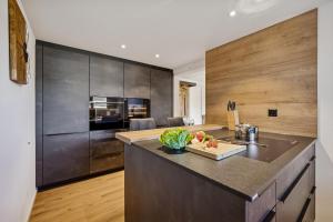 a kitchen with a large counter top and wooden walls at Suite4you Erlen l Privater Indoorpool ganzjährig beheizt & Sauna l 10min zum Bodensee, Parkplatz & WLAN in Erlen