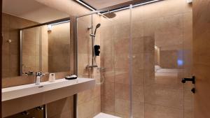 a bathroom with a shower and a sink at Hotel Catanies in Pas de la Casa
