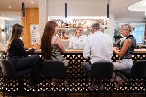 a group of people sitting at a bar at Solbadhotel Sigriswil in Sigriswil +85 photos