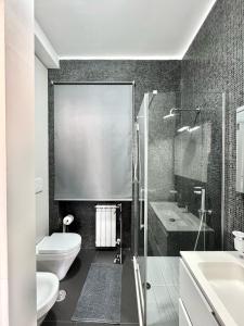 a bathroom with a shower and a toilet and a sink at The Superhost - Duomo Apt in Crotone