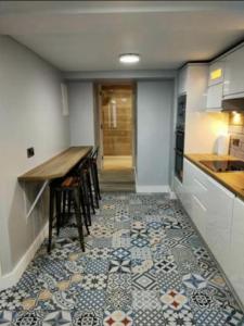 a kitchen with a table and a tile floor at The Captains Wheel in Skerries