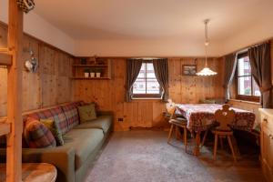 a living room with a couch and a table at Apartments Mauriz in Selva di Val Gardena