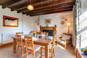 a dining room with a table and chairs and a fireplace at 3 Bed in Gower oc-hh150 in Llangennith +16 photos