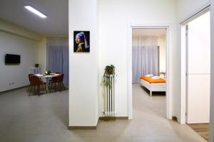 a white room with a bed and a table at Ètoile Palace Gravina in Gravina in Puglia