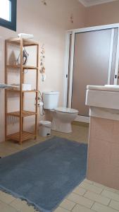 a bathroom with a toilet and a sink at Yellow Owl II Bedroom II in Campanário