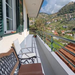 a balcony with benches and a view of a city at Yellow Owl II Bedroom II in Campanário