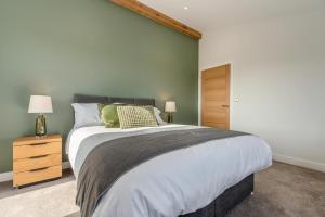 a bedroom with a large bed and a wooden cabinet at 4 Bed in Crosby oc-b31135 in Northallerton
