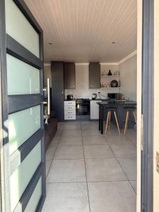 a large kitchen with a table and a counter top at 17 On Sleigh in Langebaan